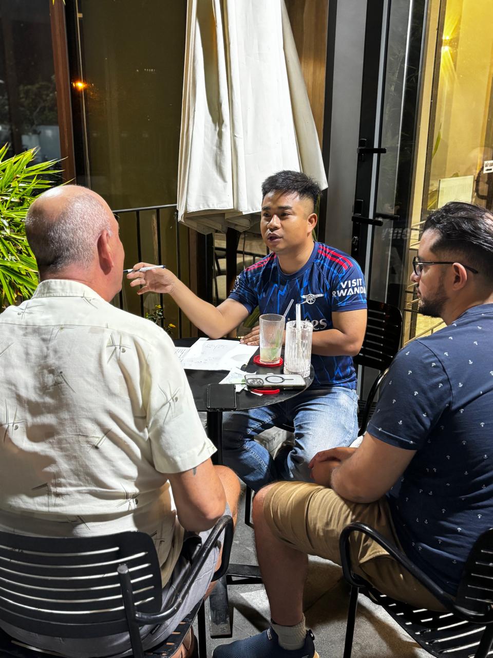 A different small group practicing together at a numbered table during the April 24, 2026 Da Nang Language Exchange session.